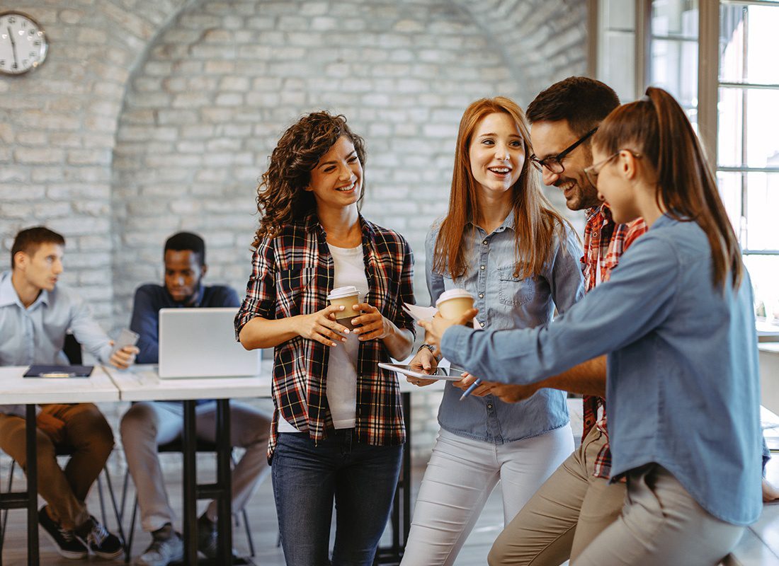 Insurance Solutions - Group of Casual Business People Smiling and Talking After a Meeting