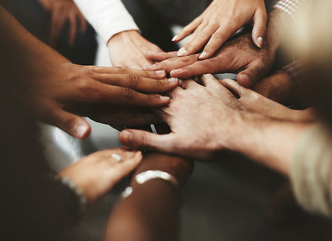 Our Events - Close Up of a Group of People Sticking Their Hands in Together